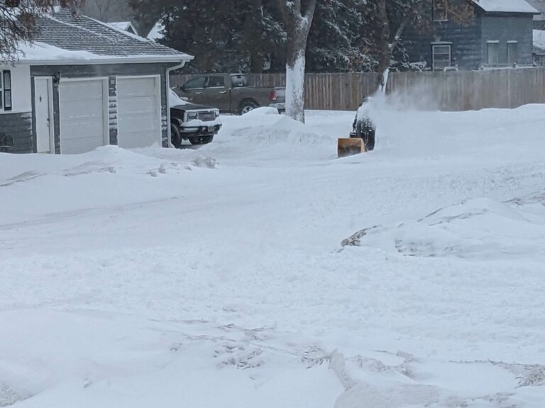 Image of an Aberdeen resident blowing snow.