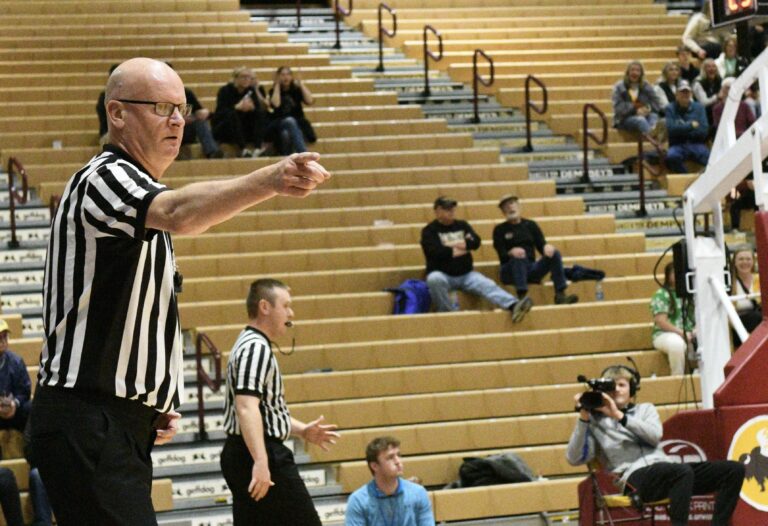 Paul Rozell officiates a game at the 2023 State B boys basketball tournament in Aberdeen. Photo by Robb Garofalo