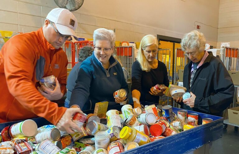 Adam Butcher, Erin Giovannini, Elyce Kastigar and Sister Kathleen Bierne help sort food at the post office during the National Association of Letter Carriers Stamp Out Hunger Food Drive on Saturday, May 13. It's estimated that 17,000 pounds of nonperishable food were donated. Photo courtesy of United Way of Northeastern South Dakota