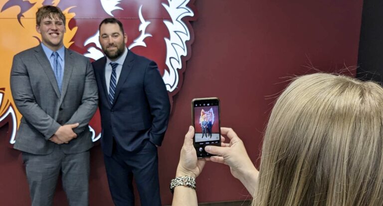 Jennifer Pischke takes a photo of her son, Gavin Pischke, who was voted governor of South Dakota Boys State. With Gavin Pischke is Boys State activities director Chris McKinney. Aberdeen Insider photo by Scott Waltman