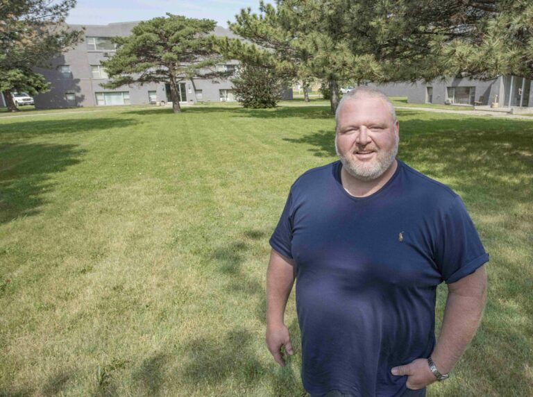 Toby Doeden stands in the courtyard of the Rockford Apartments. Doeden recently bought the properties and plans to renovate the apartment buildings. Aberdeen Insider photo by Troy McQuillen