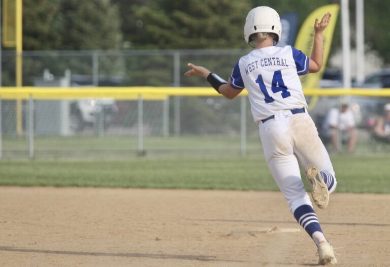 West Central junior Emillee Stofferahn throws out her hands as she rounds the basses during a 2023 Class A state semifinal game against Tea Area. Photo courtesy of South Dakota Public Broadcasting.