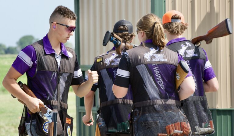 Tacen Carr is congratulated by other members of the Belle Fourche skeet team after completing a round of shooting on Friday, June 9 at the Aberdeen Gun Club. The Broncs won the skeet team title. Aberdeen Insider photo by Scott Waltman