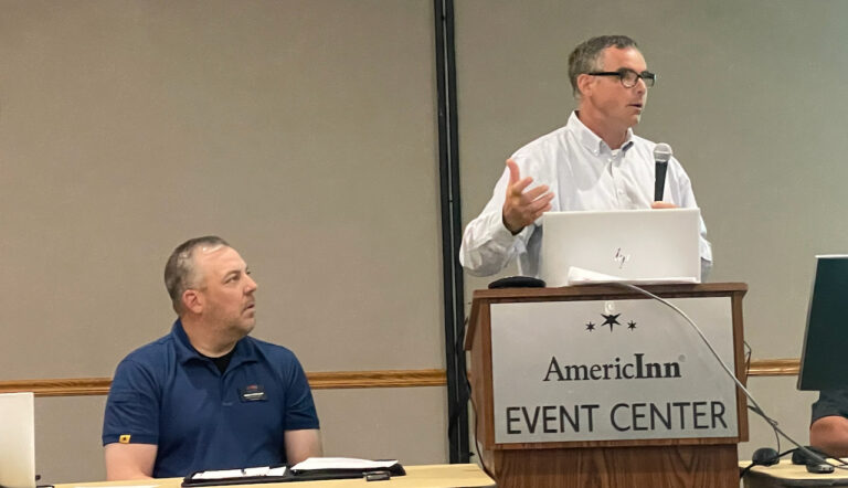 Aberdeen area South Dakota Department of Transportation engineer Mark Peterson, left, and Mike Behm, DOT director of planning and engineering for the state, discuss future highway plans during a meeting at the AmericInn on Tuesday, July 11. Aberdeen Insider photo by Elisa Sand