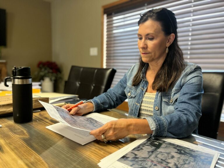 Rep. Karla Lems, R-Canton, sifts through papers regarding the carbon capture pipeline projects proposed to cross her land. South Dakota Searchlight photo by Joshua Haiar