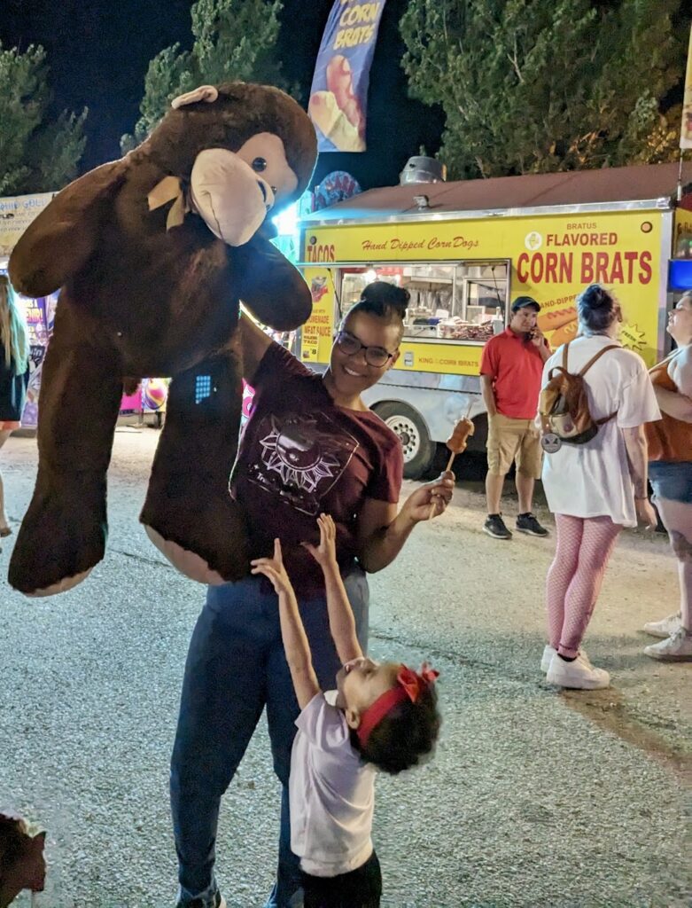 A fairgoer shows off her big prize Friday night at the Brown County Fair. Aberdeen Insider photo by Scott Waltman