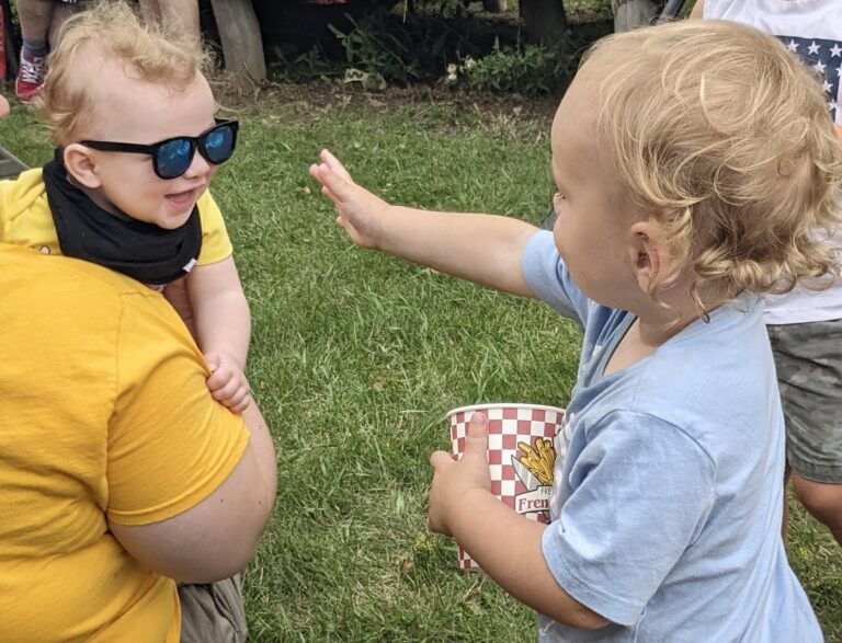 Two young friends enjoy some time at Centennial Village Saturday at the Brown County Fair. Aberdeen Insider photo by Scott Waltman