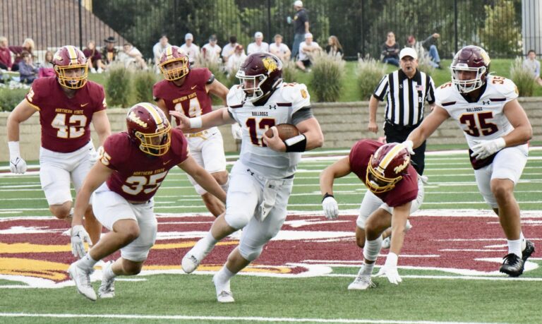 Minnesota-Duluth quarterback Kyle Walljasper eludes Northern State defenders during the Bulldogs' 41-21 victory at Dacotah Bank Stadium on Saturday, Sept. 9 Aberdeen Insider photo by Scott Waltman