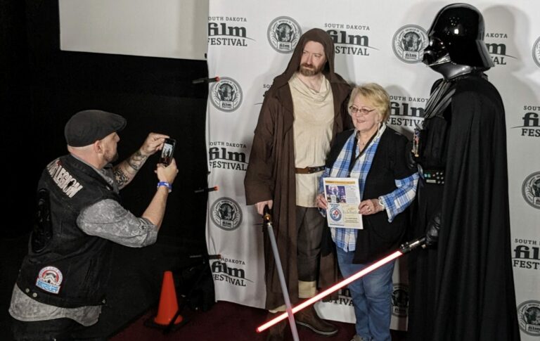 Members if the 501st Legion take a photo with Lois Flanigan of Aberdeen Saturday, Sept. 16 at the South Dakota Film Festival. Kory Willard of Sioux Falls is dressed as Darth Vader and Tommy Schwartz of Sioux Falls is dressed as Obi-Wan Kenobi. Taking the photo is Tom Rosy, one of the directors of "Behind the Bucket: A Garrison Story." Aberdeen Insider photo by Scott Waltman