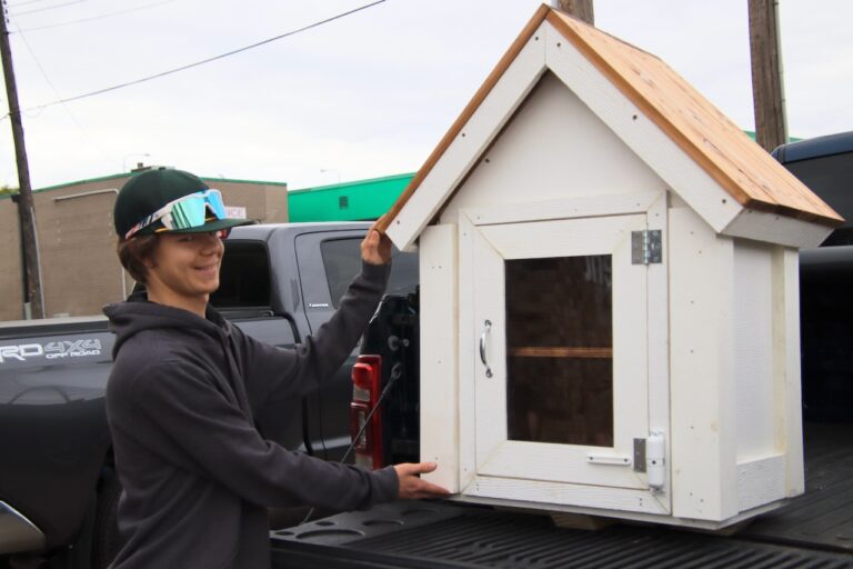 Logan Cybulski stands next to the mini food pantry prior to installation on Tuesday, Sept. 26. Aberdeen Insider photo by Elisa Sand