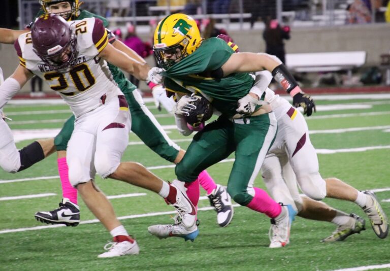 Aberdeen Roncalli running back Brody Weinmeister attempts to pull away from Webster Area's Brent Bearman during a game at Dacotah Bank Stadium earlier this season. Both teams have qualified for the high school football playoffs. Aberdeen Insider photo by Robb Garofalo lo