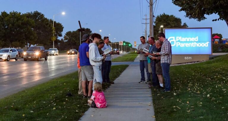 Members of Jericho Wall, an all-male anti-abortion prayer group, pray the rosary in 2021 outside Planned Parenthood in Sioux Falls. Photo courtesy of The Argus Leader