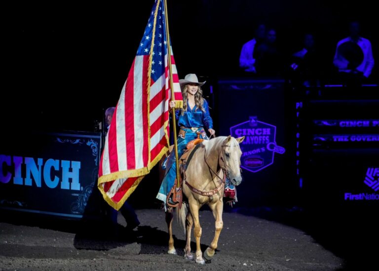 Gov. Kristi Noem, with American flag in hand, rides into the Cinch Playoffs Governor’s Cup rodeo in Sioux Falls in September 2023. Photo courtesy of governor’s office
