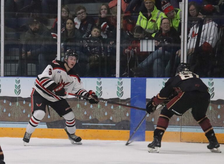 Aberdeen Wings defenseman Drew Mackie sends the puck into the Minot zone during a game Saturday, Jan. 20 at the Odde Ice Center. Aberdeen Insider photo Robb Garofalo