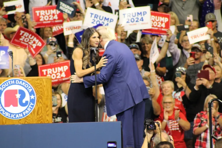 Gov. Kristi Noem greets former President Donald Trump at a rally Sept. 8, 2023, at The Monument in Rapid City. South Dakota Searchlight photo by Seth Topper