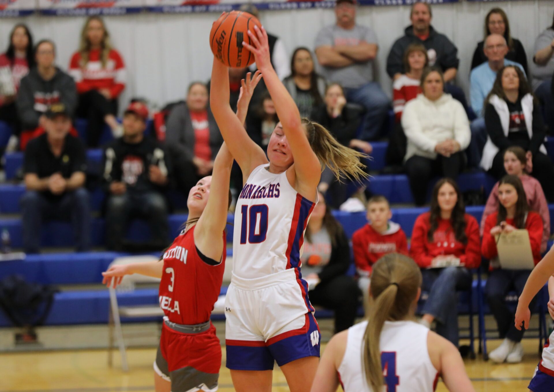 Warner's Ava Nilsson grabs a rebound over Britain-Hecla's Heather Storbakken during a Region 1B semifinal Thursday, Feb. 22 in the Warner gym. Photo courtesy Angie Vetter