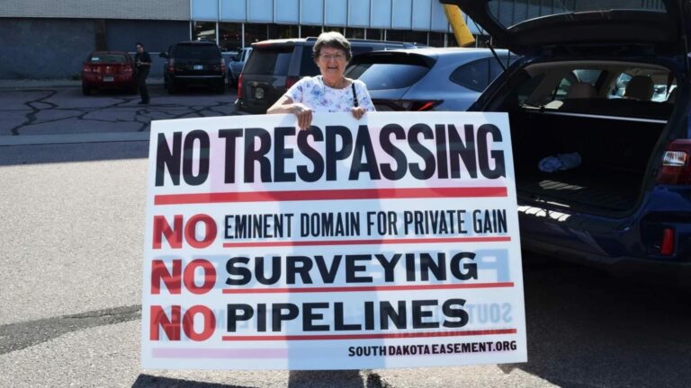 Opponents of the CO2 pipeline and the use of eminent domain have organized and remain vocal in their opposition. Betty Strom of Sioux Falls, S.D., owns land along the pipeline route and made her positions known outside a hearing in 2022. Argus Leader file photo.