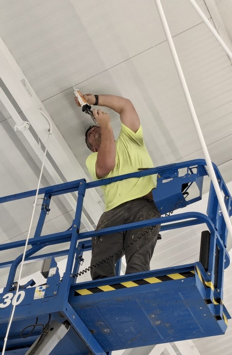 Jason Dibbern caulks the interior seams of the roof at Aberdeen K.O. Lee Public Library on Monday, March 4. Aberdeen Insider photo by Scott Waltman