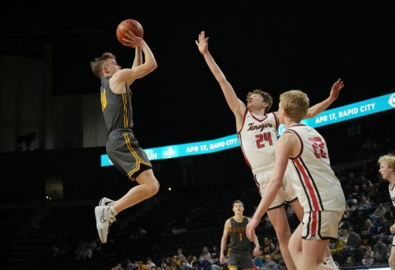 Groton Area's Lane Tietz takes a jump shot over Vermillion's Carter Hansen during the seventh place game Saturday, March 16 at the Class A state tournament in Rapid City. Photo courtesy SDPB