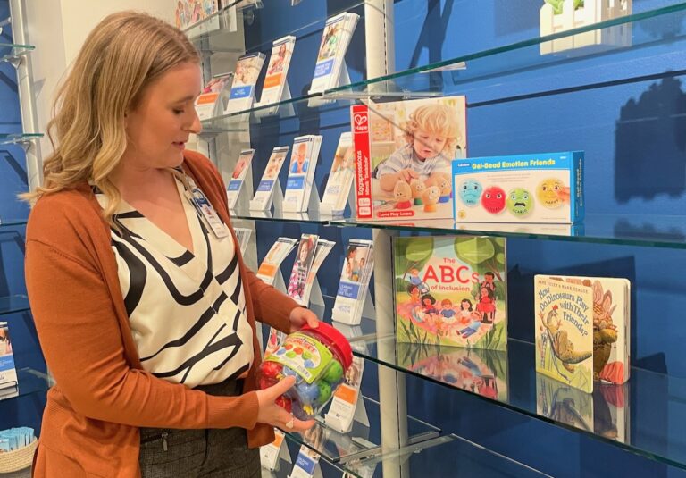 Amanda Daniels, family life educator at the Sanford Children's CHILD services, looks over some of the items available through the group's toy-lending library. Aberdeen Insider photo by Elisa Sand.