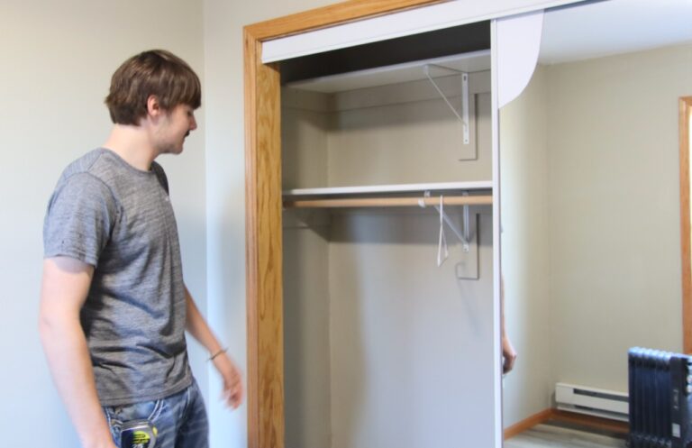 Jaeger Kampa shows the inside of the closet in the little house built by Groton shop students. Aberdeen Insider photo by Elisa Sand.