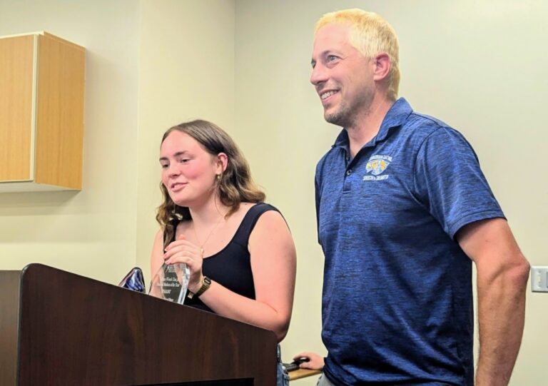 Recent Central High School graduate Breanna Wollman and debate coach Kerry Konda discussed the National Speech & Debate Tournament with the Aberdeen Public Board of Education on Monday, June 24. Konda dyed his hair blonde because of the success his students had at the tournament. Photo courtesy of the Aberdeen Public School District.