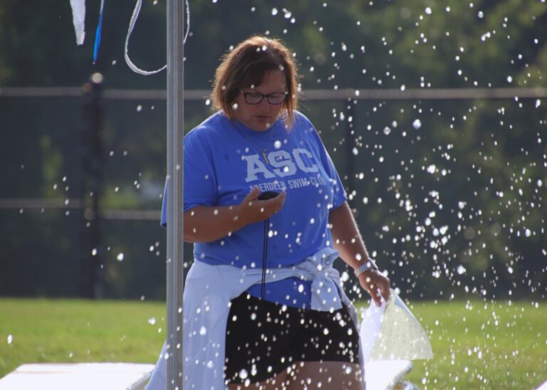 Aberdeen Swim Club coach Lisa Jorgensen checks the stopwatch during lap practice Monday, July 8 at the Aberdeen Aquatic Center. Aberdeen Insider photo by Robb Garofalo