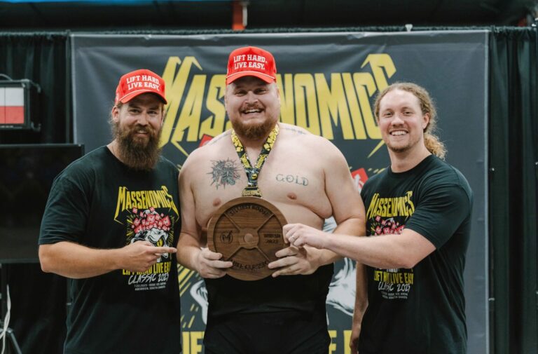 Massenomics co-owners Tanner Baird, left and Tom DeFea, right, present Sioux Falls lifter Bryce Wollman with an award following last year's Lift Hard, Live Easy Classic. Courtesy photo.