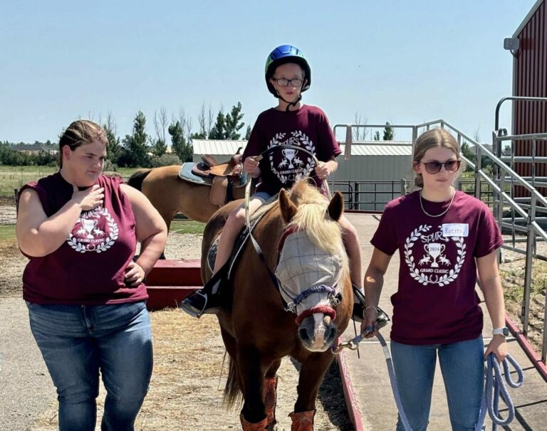 Lucas Berreth rides Belle during the SPURS Grand Classic at SPURS Therapeutic Riding Center on Thursday, Aug. 1. Helping out are volunteers Sage Mortenson, left, and Kierra Rivett. Photo courtesy of Angie Cleberg, United Way of Northeast South Dakota.