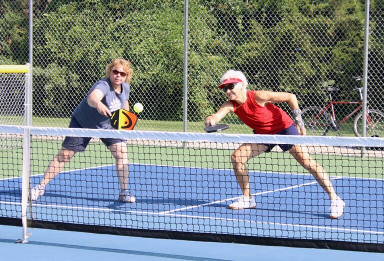 Loretta Vilhauer, left, and Jan Schochenmaier play pickleball during the Senior Games earlier this summer at Manor Park. Pickleball fans plan to help pay to add outdoor courts in town. Aberdeen Insider photo by Robb Garofalo.