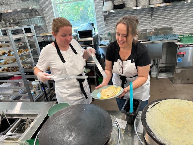 Dominika Blum, right. prepares a crepe at Krave with Jaslyn Clausen. Krave opened for business on Tuesday, Aug. 13. Courtesy photo.