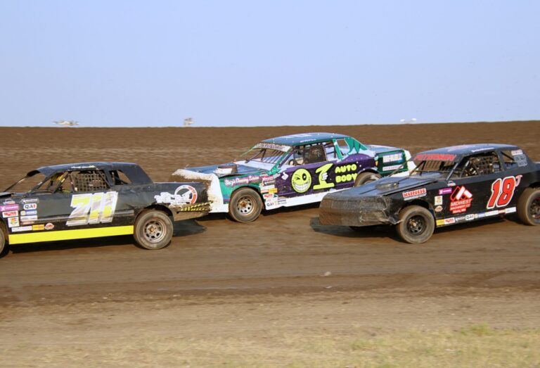 Chris Serr, center, battles Ken Clements, left, and Justin Peterson during a heat race earlier this summer at Brown County Speedway. Aberdeen Insider photo by Robb Garofalo.