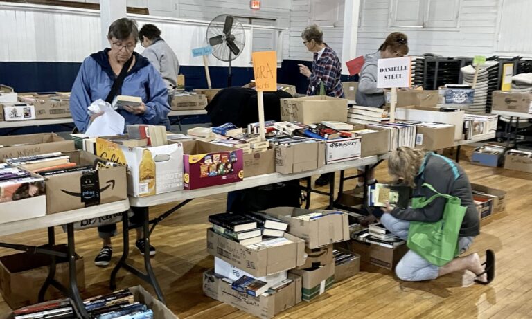 Book lovers look for deals during the 2023 Delta Kappa Gamma book sale in the Wylie Pavilion. This year's sale runs from 9 a.m. to 7 p.m. on both Thursday, Aug. 22 and Friday, Aug. 23 and from 8 a.m. to noon on Saturday, Aug. 24. All of the proceeds go to scholarships for women who are majoring in education at Northern State University or grants women who are already in the education field. Photo courtesy of Gayle Bortnem.