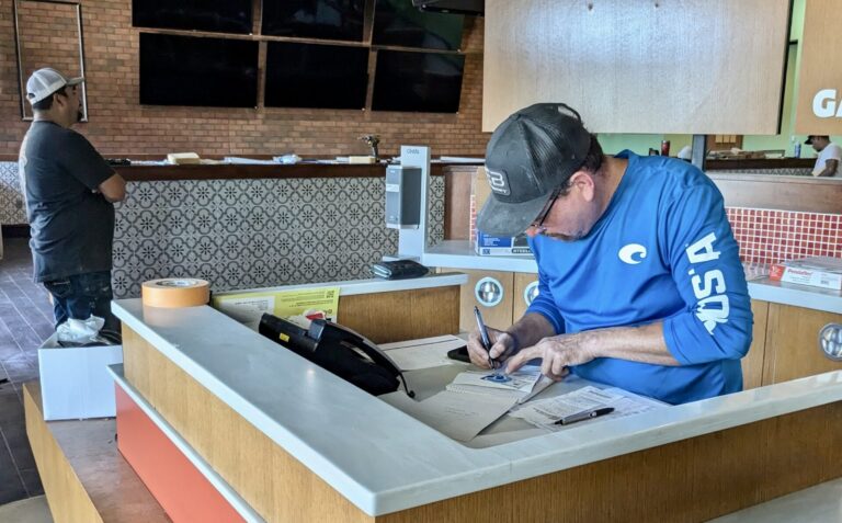 Marao Escalera works on paperwork at what will be Santo Tequila, a Mexican restaurant in the former Buffalo Wings & Rings building. Escalera will be manager and co-owner. Aberdeen Insider photo by Scott Waltman.