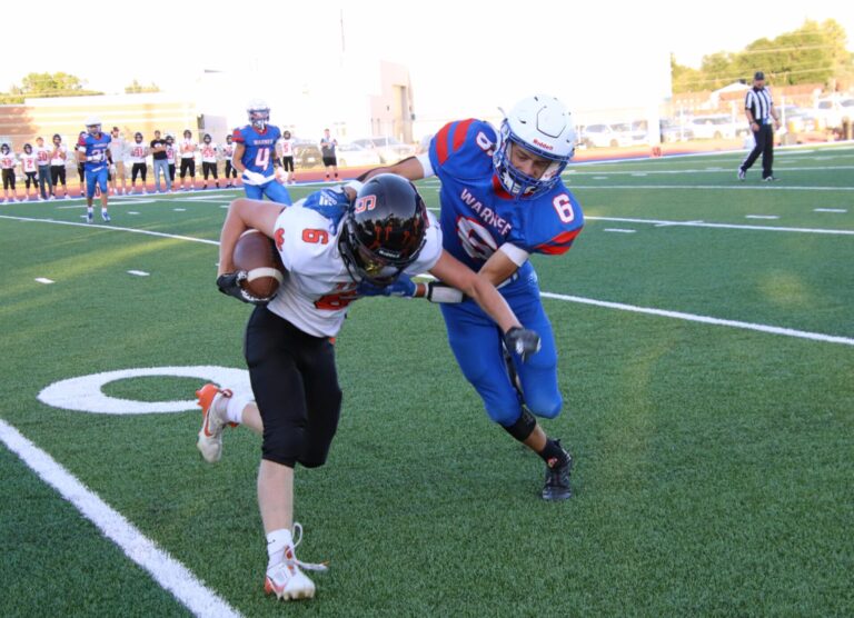 Warner's Devon Fischbach stops Ipswich's Rasmus Loken for a short gain in the first quarter Friday, Sept. 6 in Warner. Aberdeen Insider photo by Robb Garofalo