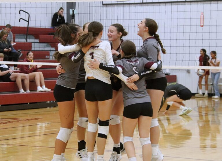 Members of the Aberdeen Christian volleyball team celebrate after their five-set win over Roncalli Monday, Sept. 23 in the Aberdeen Christian Gym. Aberdeen Insider photo by Robb Garofalo.