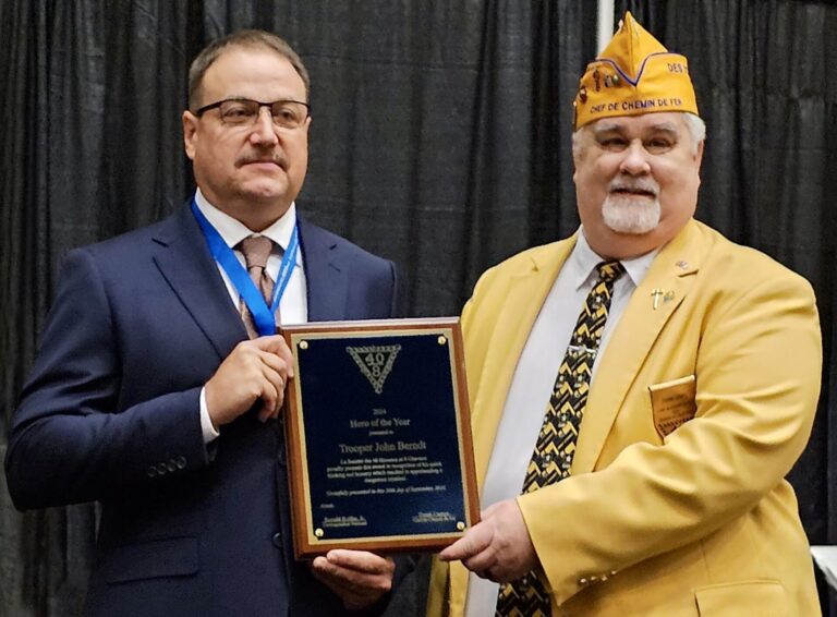 Society of Forty Men and Eight Eight Horses Chef de Chemin de Fer Frank Campo presents the group's National Hero of the Year award to South Dakota Highway Patrol Trooper John Berndt during the group's National Promenade in Sandusky, Ohio, in September. Courtesy photo.