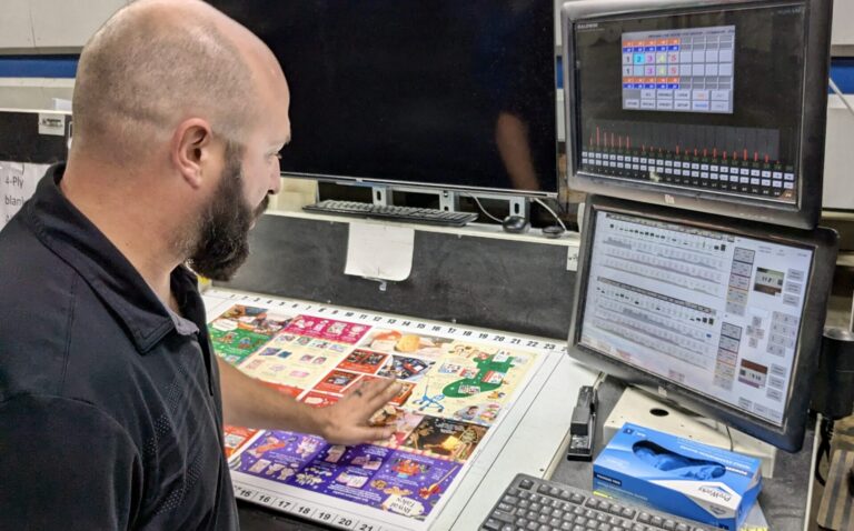 Midstates Group co-owner Justin Feickert explains the features of a press at the printing plant in Aberdeen. Aberdeen Insider photo by Scott Waltman.