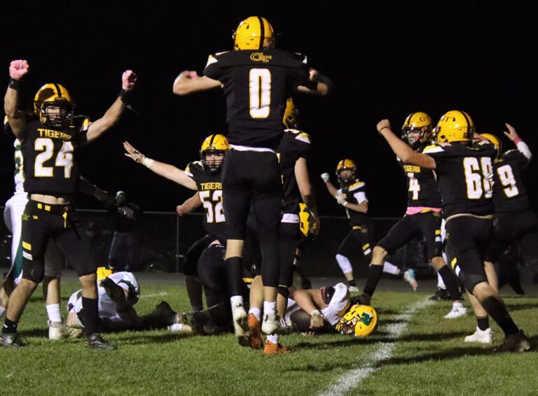 Members of the Groton defense celebrate after stopping Aberdeen Roncalli's Zane Backous to end the game in the second overtime Friday, Oct. 4 in Groton. The Tigers won 29-23. Aberdeen Insider photo by Robb Garofalo.