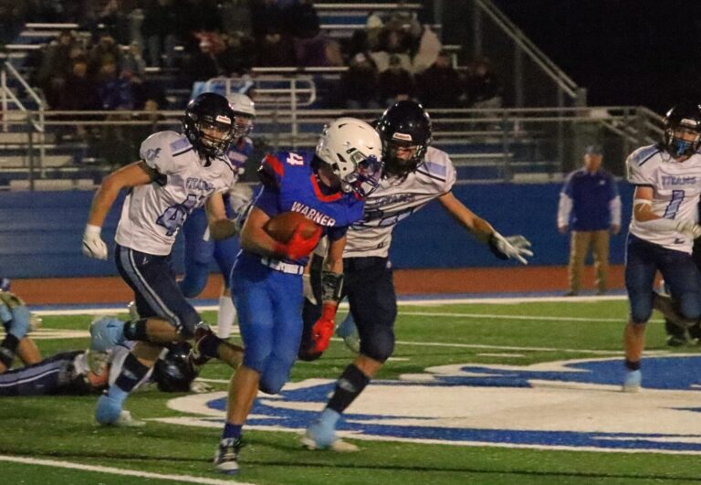 Warner's Jesiah Baum breaks to the outside and tries to outrun Leola/Frederick's Noah Kippley and Milo Sumption (41) during the second quarter of their game Friday, Oct. 18 in Warner. The Monarchs won 21-0. Aberdeen Insider photo by Robb Garofalo.