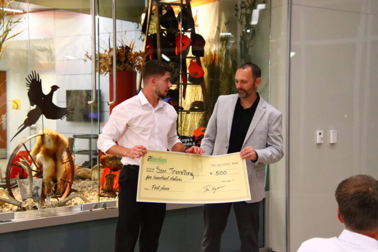 Aberdeen Development Corp. CEO Tim Hanigan presents Sam Tremelling with a $500 check for winning the Northern State Idea Pitch Competition. Aberdeen Insider photo by Shannon Marvel.