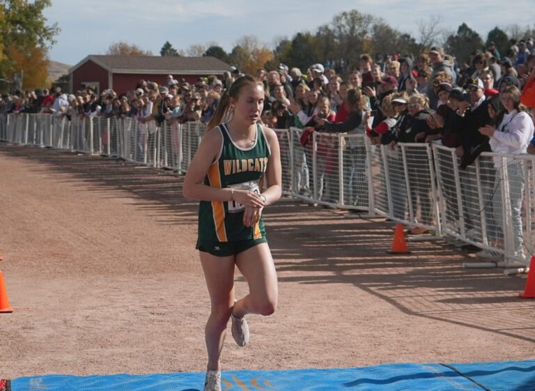 Northwestern's Ella Boekelheide crosses the line first during the Class B girls state cross-country meet in Rapid City. She won the race. Photo courtesy of South Dakota Public Broadcasting.