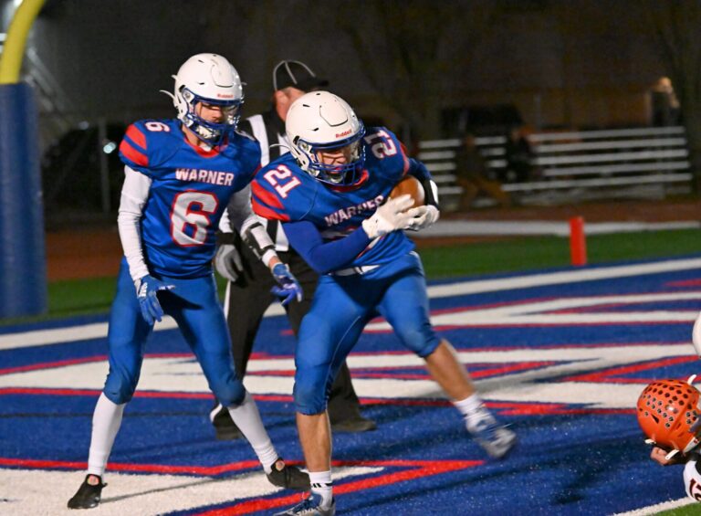 Warner's Payton Volk steps into the end zone during the first quarter of the Monarchs' Class 9A quarterfinal playoff game against Philip. Joining Volk in the end zone is teammate Devon Fischbach. Aberdeen Insider photo by Robb Garofalo.
