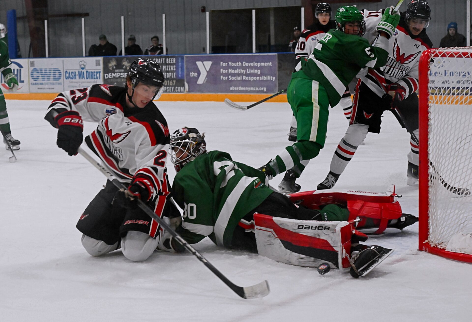 Aberdeen Wings forward Cale Saterdalen tries to flip the puck from his knees over the pads of Watertown goalie Phileas Lachat during the second period of their game Wednesday, Nov. 27 at the Odde Ice Center. Leo Bulgakov had a hat trick as Aberdeen picked up a 3-0 victory. Aberdeen Insider photo by Robb Garofalo.