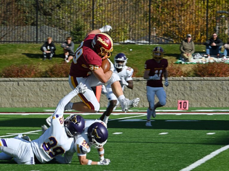 Northern State's Wyatt Block hurdles Minnesota State's Derek Whaley (39) and Brock Galetich en route to a 22-yard touchdown run Saturday, Nov. 2 at Dakota Bank Stadium. Aberdeen Insider photo by Robb Garofalo.