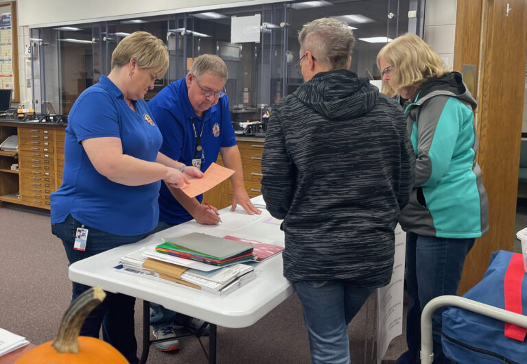 Brown County Auditor Lynn Heupel and Deputy Auditor Dave Engraf check in vote center equipment and documentation from the Warner poll workers. Aberdeen Insider photo by Elisa Sand.