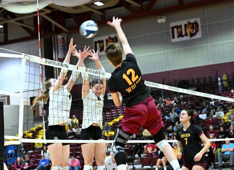 Northern State's Natalia Szybinska hits over the block attempt by Southwest Minnesota's Sydney Thein, left and Emma VanHeel during the fifth set of their match Saturday, Nov. 16 in Wachs Arena. Aberdeen Insider photo by Robb Garofalo