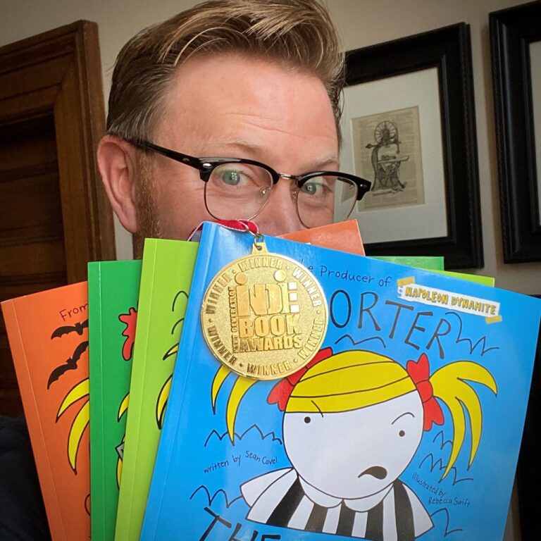 Sean Covel hides behind a selection of Porter the Hoarder books he's published. Courtesy photo.