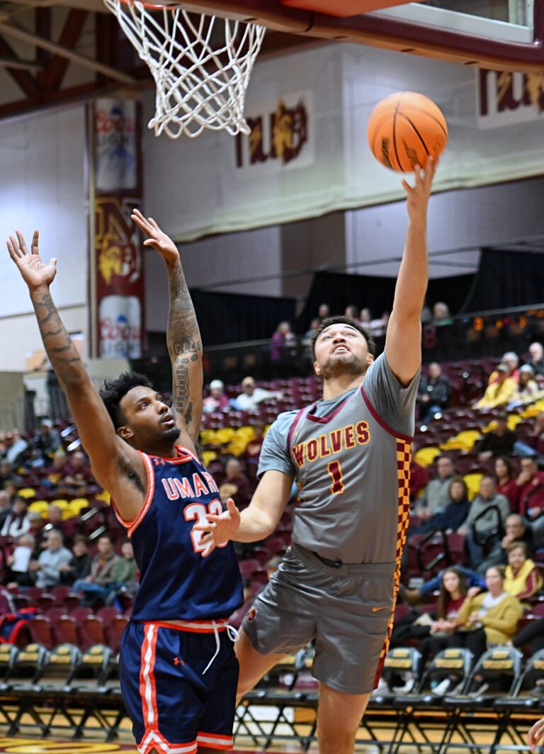 Northern State Tobi Obiora scores on a layup past Mary's Xavier Lewis during the first half of their game Tuesday, Nov. 26 at Wachs Arena. Mary held off a second-half NSU rally to win. Aberdeen Insider photo by Robb Garofalo.