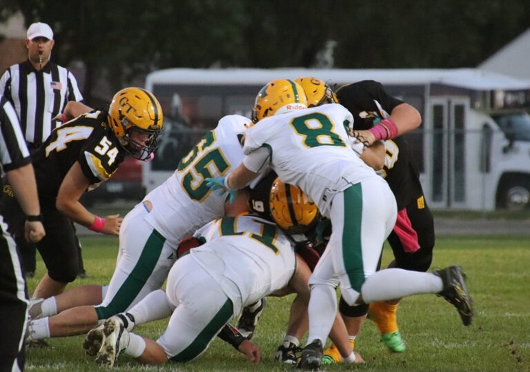 Aberdeen Roncalli's Zane Backous, bottom, combines with teammates Jean Anthony Thomas, right, and Carter Samson to stop Groton Area's Korbin Kucker during their game Friday, Oct. 4 in Groton. Backous was named to the Class 11B all-state team. Aberdeen Insider photo by Robb Garofalo.